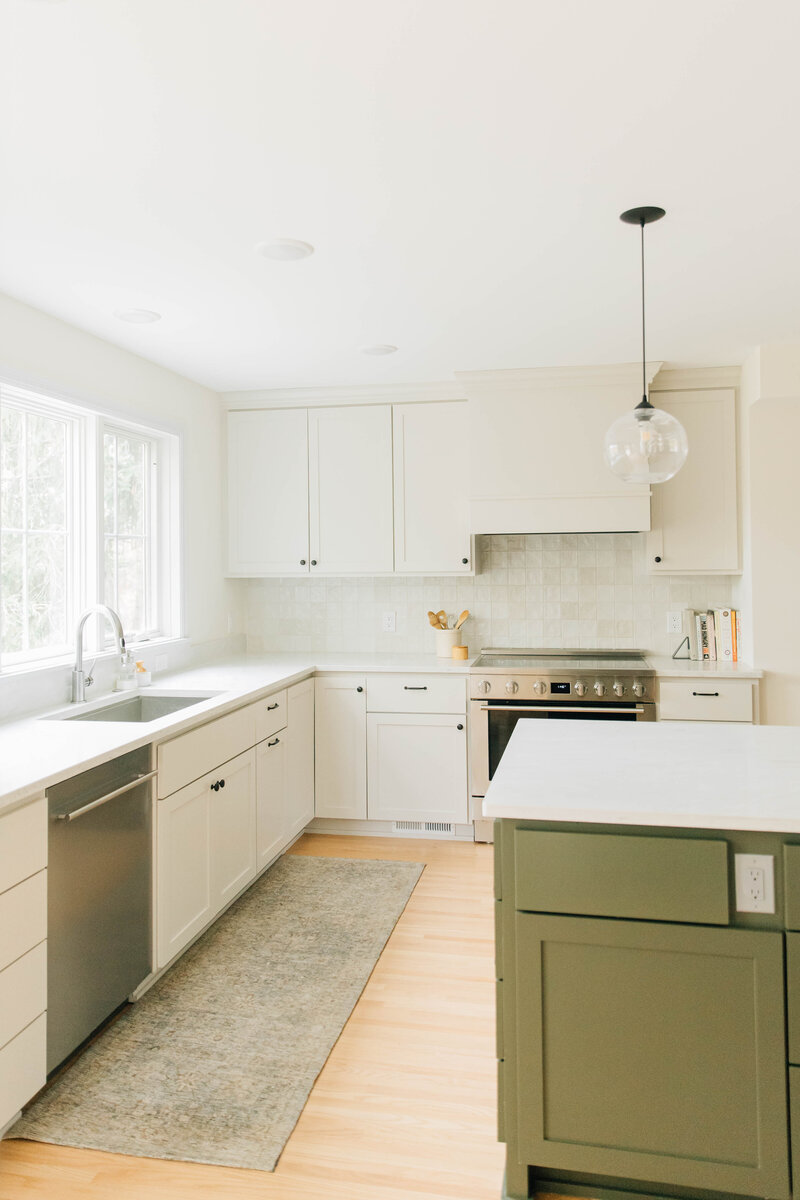 Light Wood Floors and Black Tile Entryway with Countertop Stools and Built Ins in Minnesota Home Remodel Project