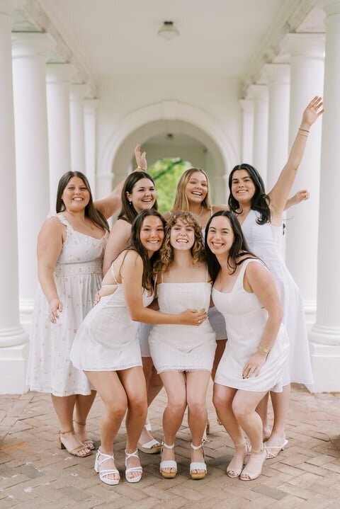 Group of senior girls in white dresses posing