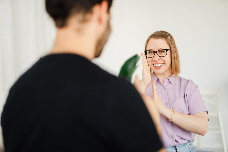 Stephanie uses her hands to show how the placement of sound should feel in the mouth.