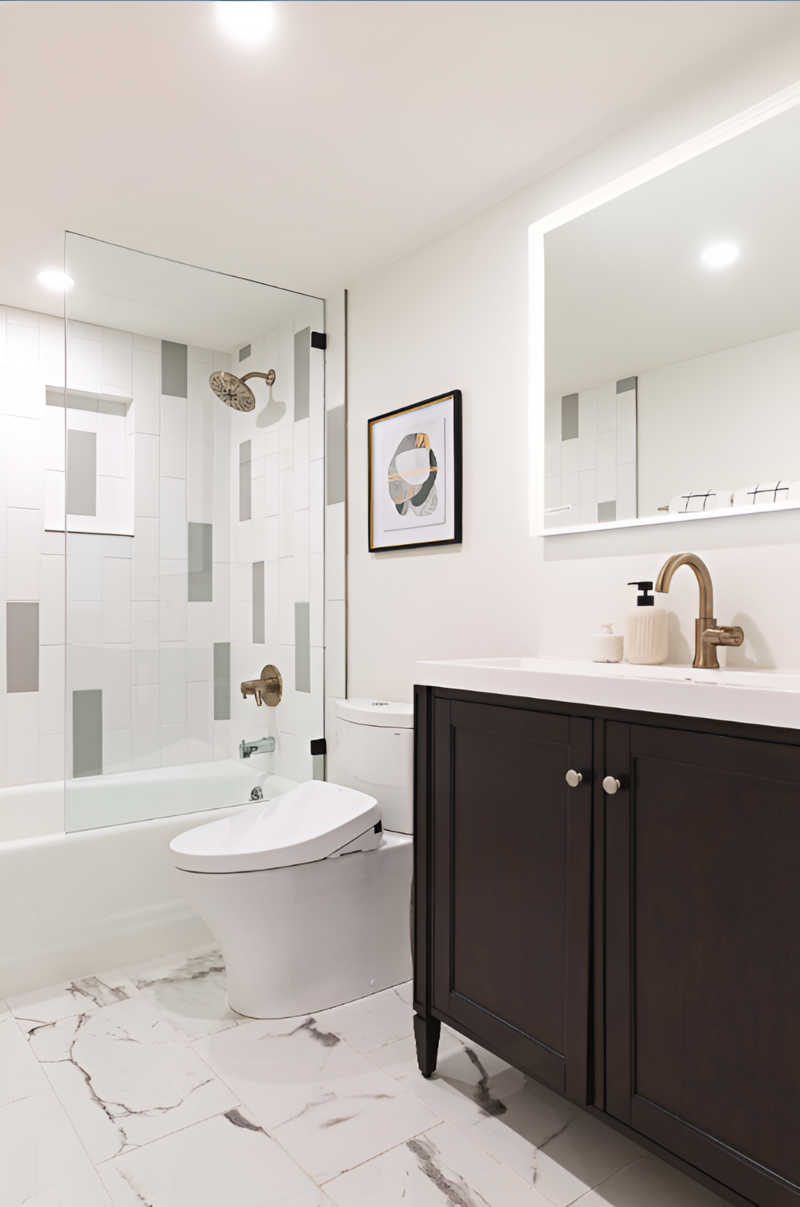 Wide shot of a modern bathroom fit with a warm wood vanity and bright textured tile accents by Sister Studio.