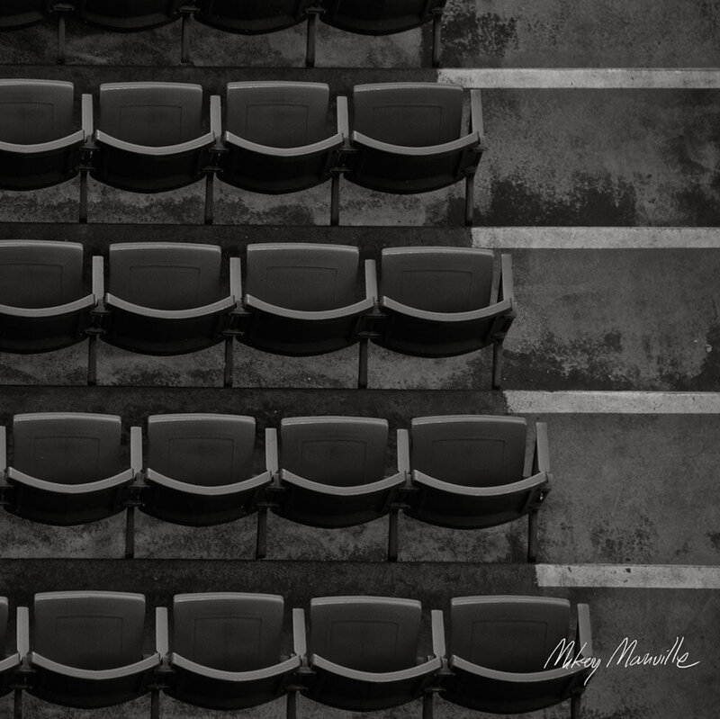 Original Artwork Album Cover Title Indiana Beneath The Leaves Musician Mikey Manville empty rows of stadium seats next to staircase overhead view black and white