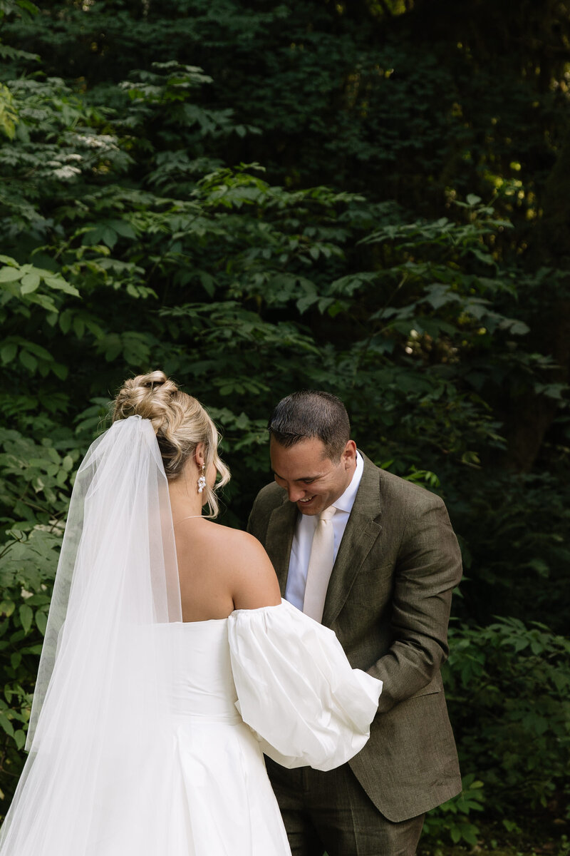 Emotional first look moment between bride and groom at outdoor wedding in Vancouver, Washington