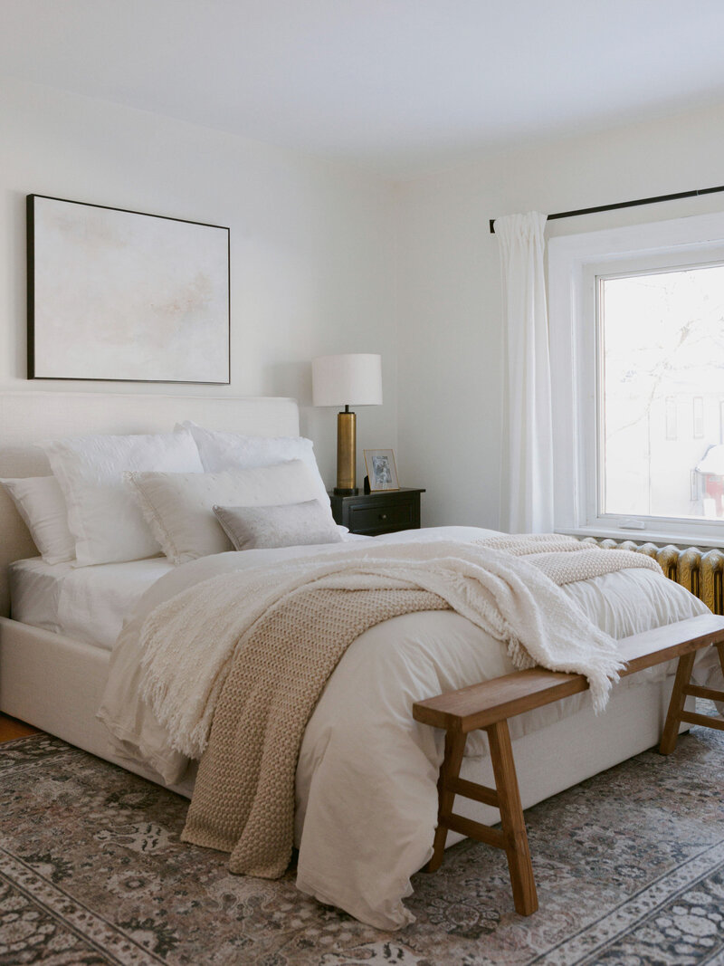 staged bedroom with upholstered cream bed  in character home