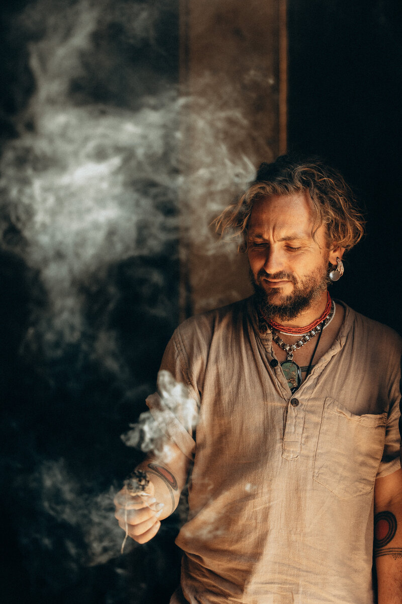 Candid moment with John Butler during a smoke ceremony at a retreat, photographed by a specialist in event photography Sunshine Coast.