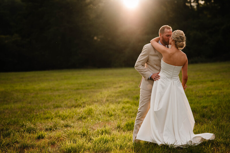 Bride and groom posing for portrait with white walls