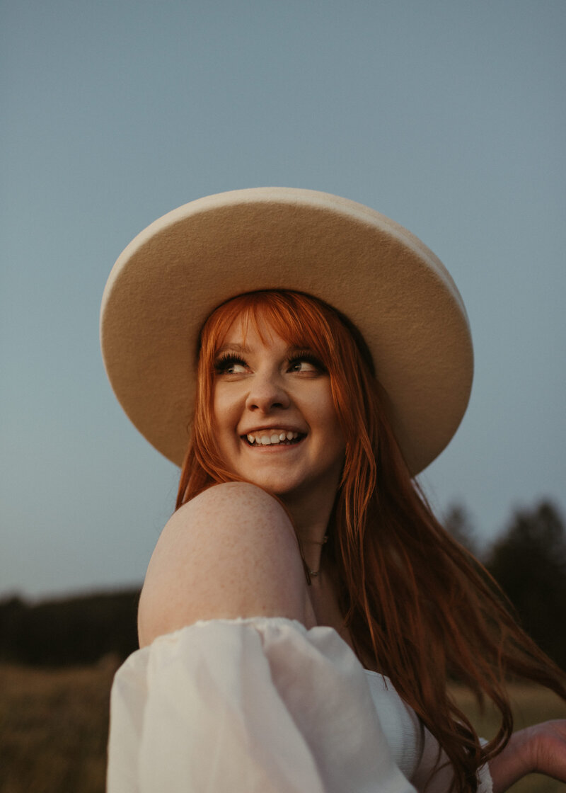 woman smiling and wearing gigi pip hat