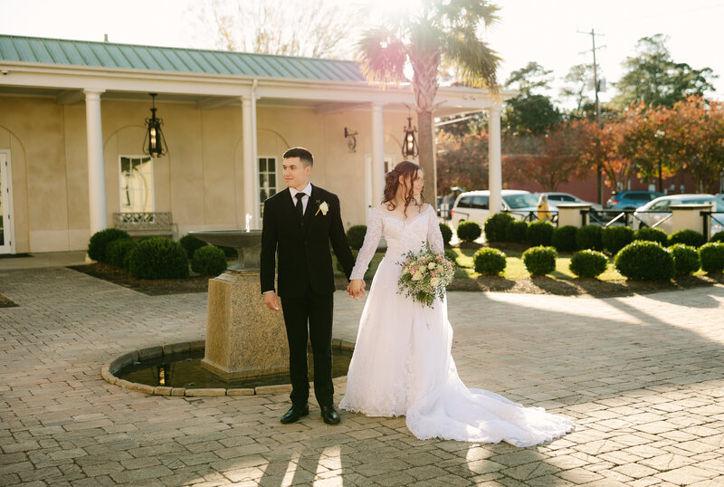 bridal portraits of couple standing outside under palm trees