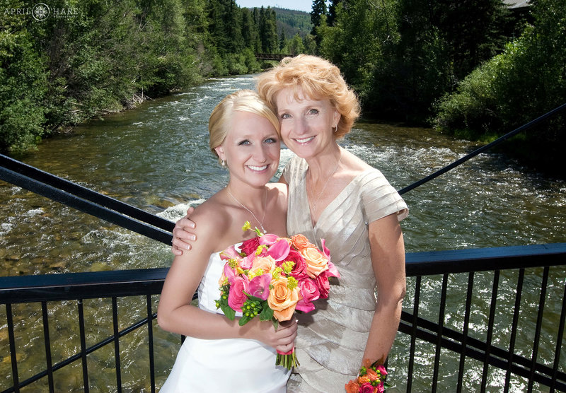 Bride and mom get a picture together on a bright sunny day at Silverthorne Pavilion