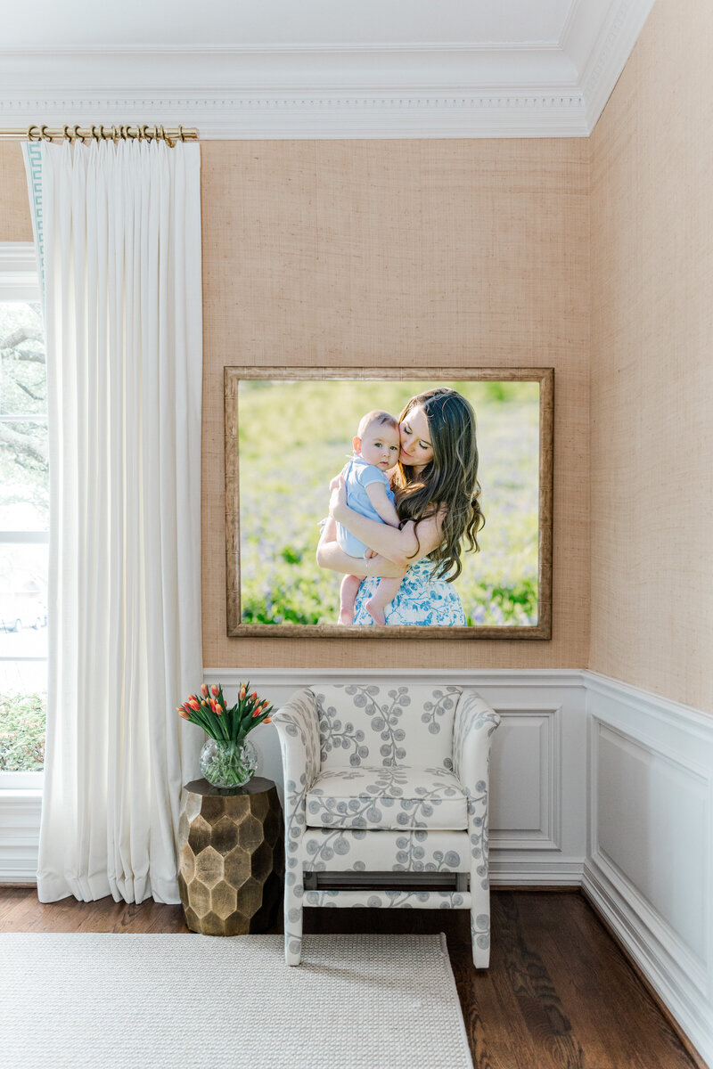Interior of a luxury home with a framed photo of a mother holding her baby hanging on the wall.