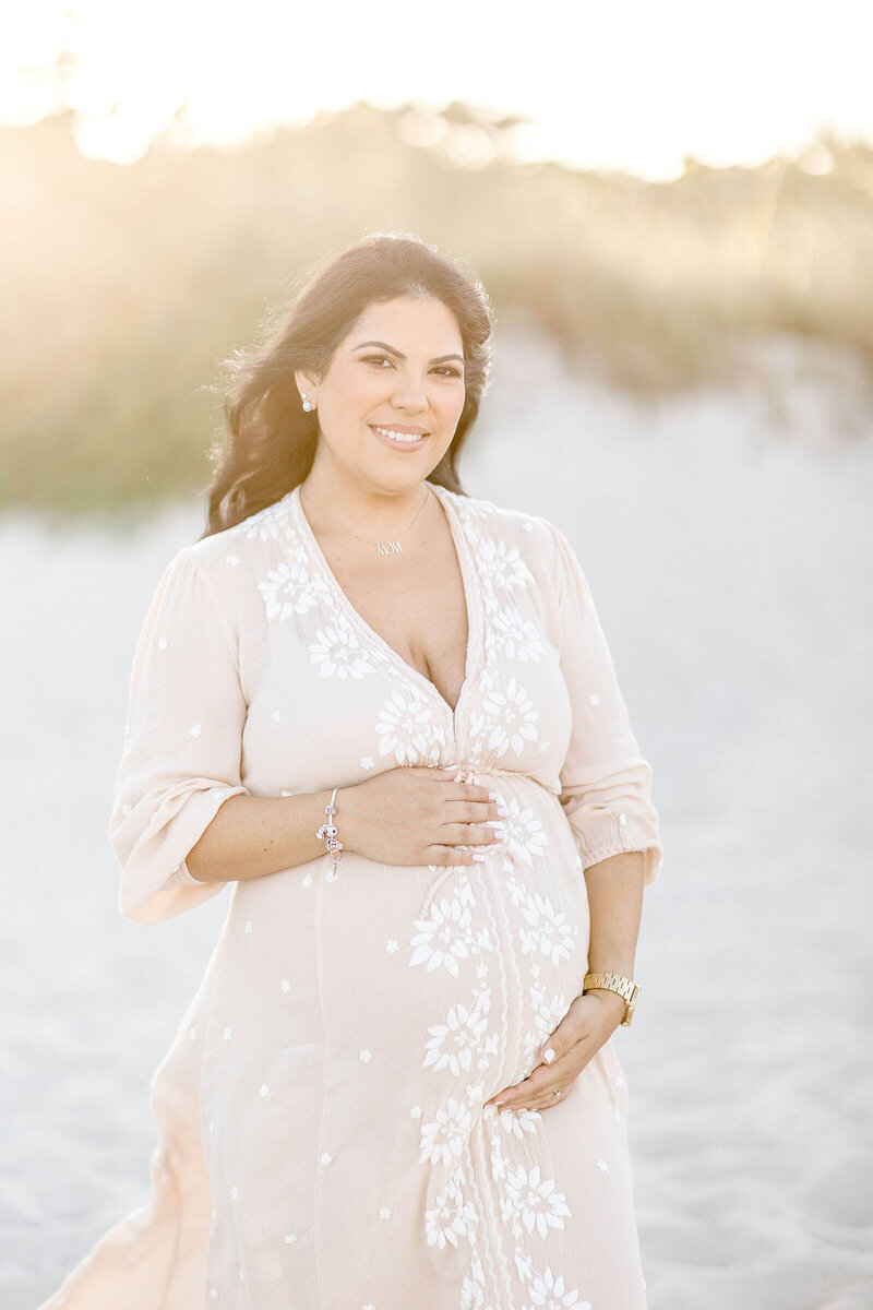 Couple walking down the beach  with their Miami Maternity Photographer Ivanna Vidal Photography