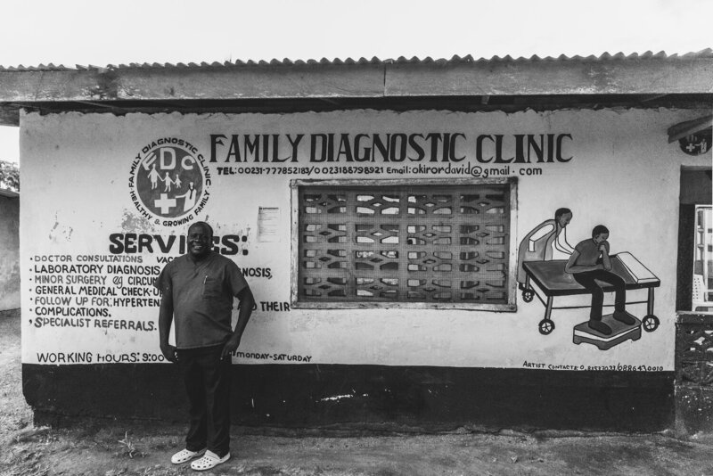 Doctor In Liberia Standing In Front Of The Family Diagnostic Clinic, From The Liberia Collection
