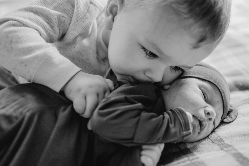 Black and white photo of brothers taken by Loveland Newborn Photographer