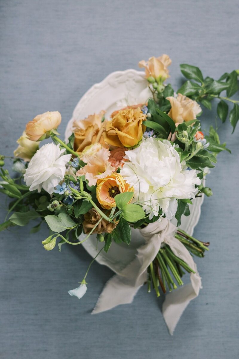 White, cream, tan, apricot and light blue bridal wedding bouquet with silk ribbons