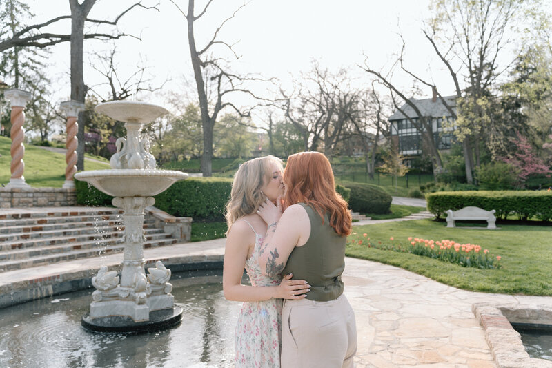 An engaged couple having fun at Powell Gardens during their engagement photoshoot.