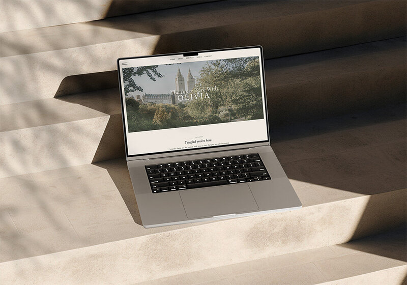 A laptop on steps showcasing custom Showit web design with a serene outdoor setting.