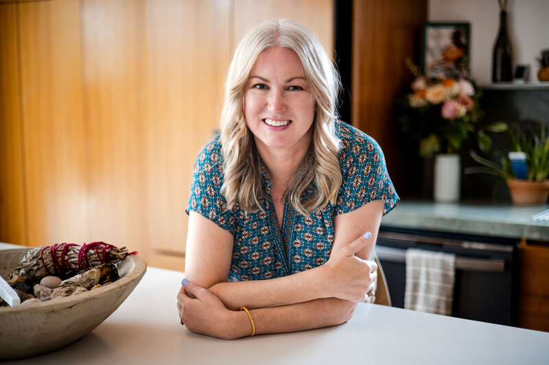 Woman on counter leaning towards camera