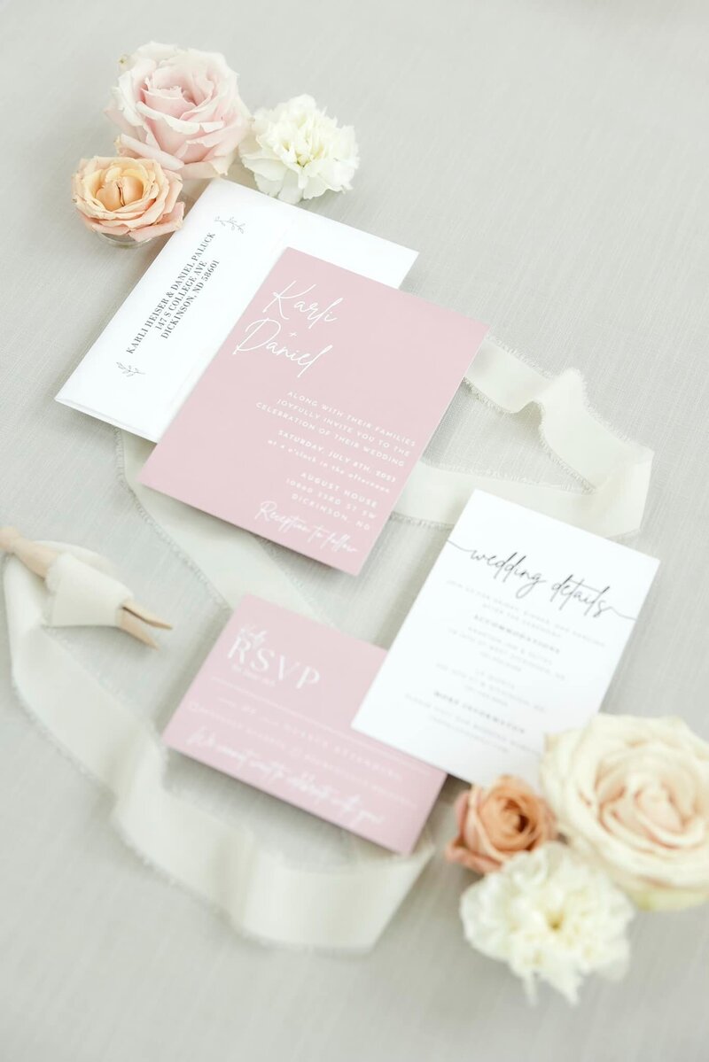A beautifully arranged display of the wedding invitations at the August House Venue.