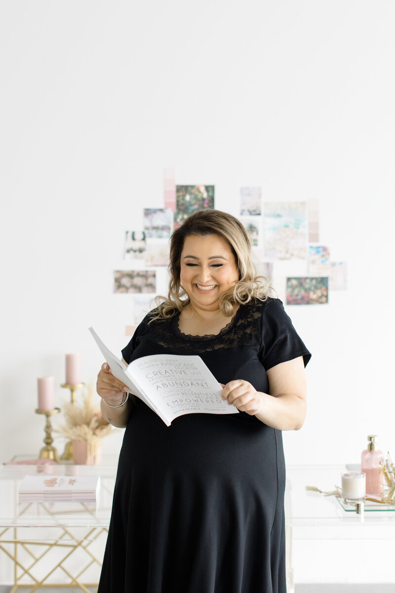 Jessie Khaira event planner looking into a white book