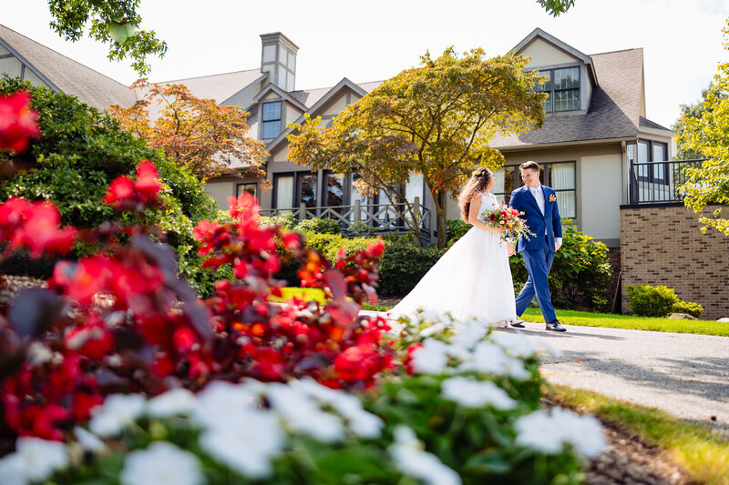 Golden hour at Cornman Farms in Ann Arbor Michigan while a wedding couple holds hands and walks away