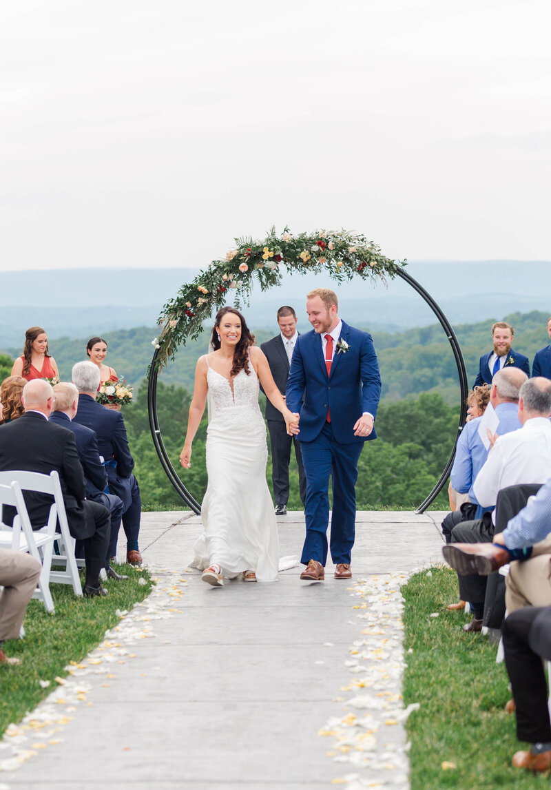 married couple walking down the aisle at Howe Farms