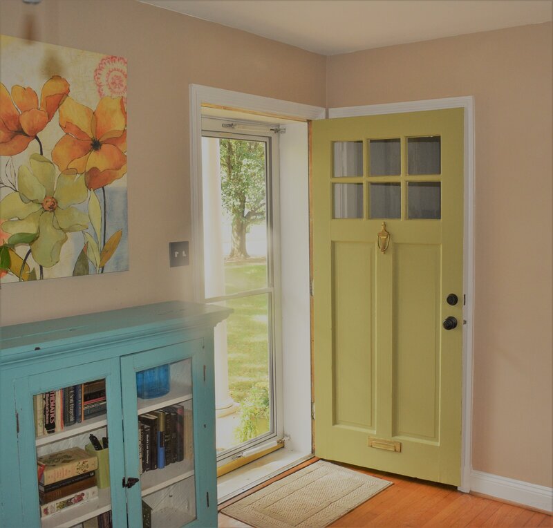 Bright green door and teal bookshelf