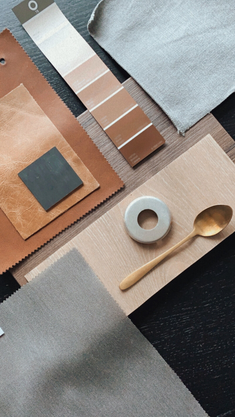 Flatlay of modern design materials, fabric swatches, and décor elements representing real estate investment planning and property strategy — Mary Pernicano Real Estate.