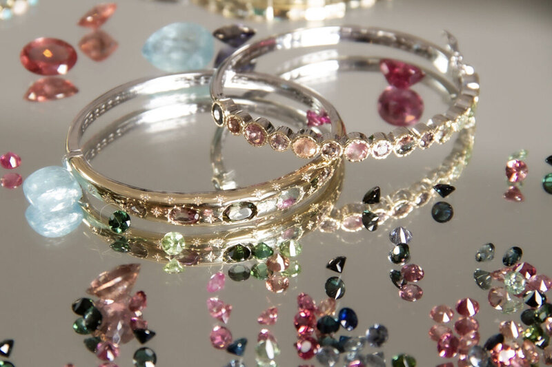 Brand Photography close up of products bracelets gem stones on silver tray