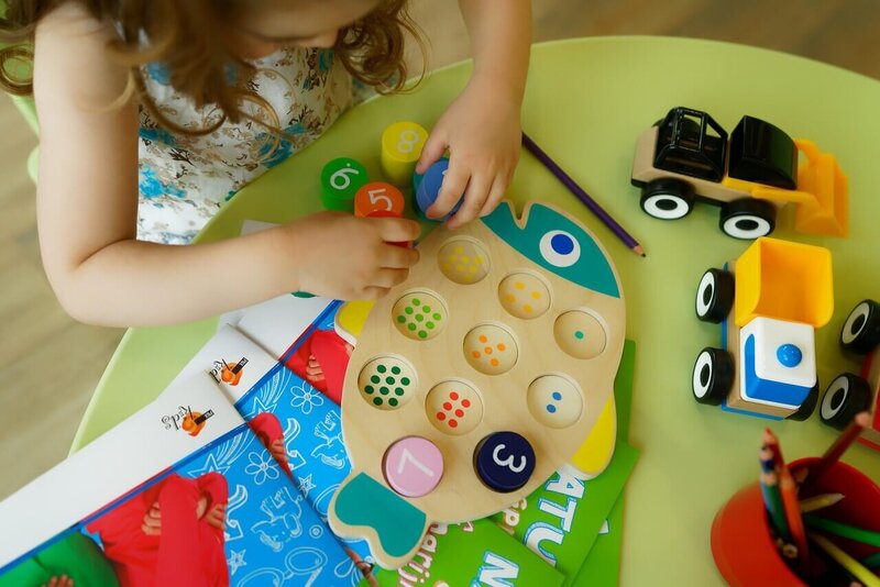 overhead shot of toddler playing with colorful toys