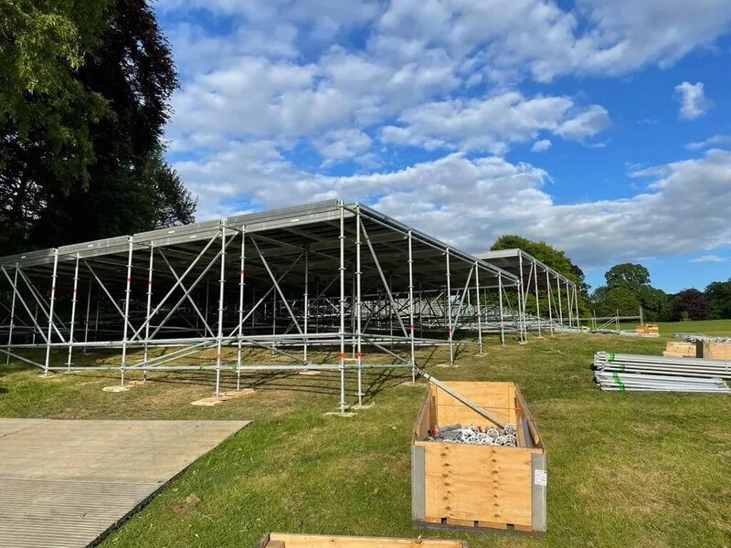 a large scaffolding structure to hold a marquee floor up