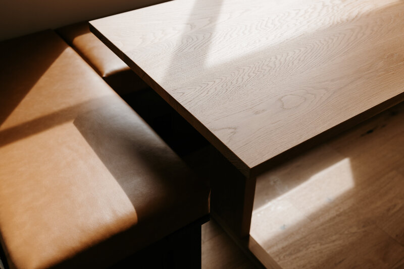 Styled arrangement of lifestyle products including candles and home decor on a wooden table.