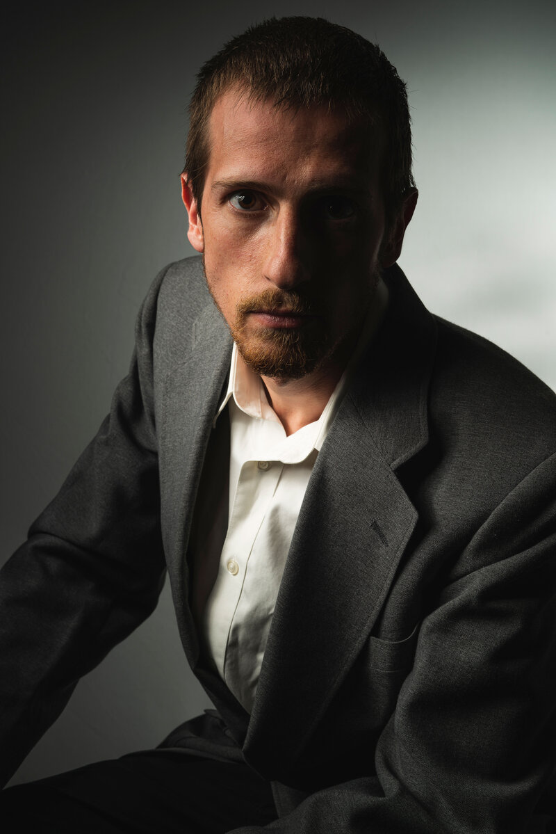 jerameyis wearing a suit and looking into the camera