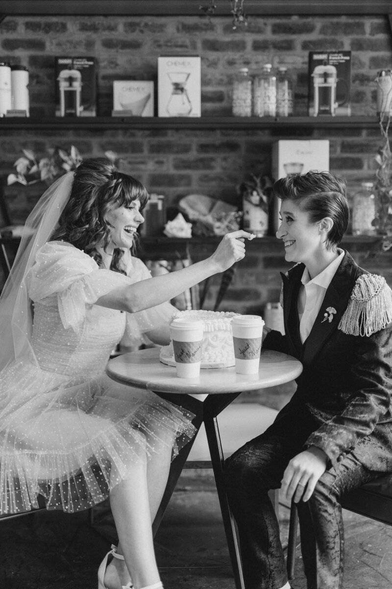 bride and bride sitting at a table drinking coffee together