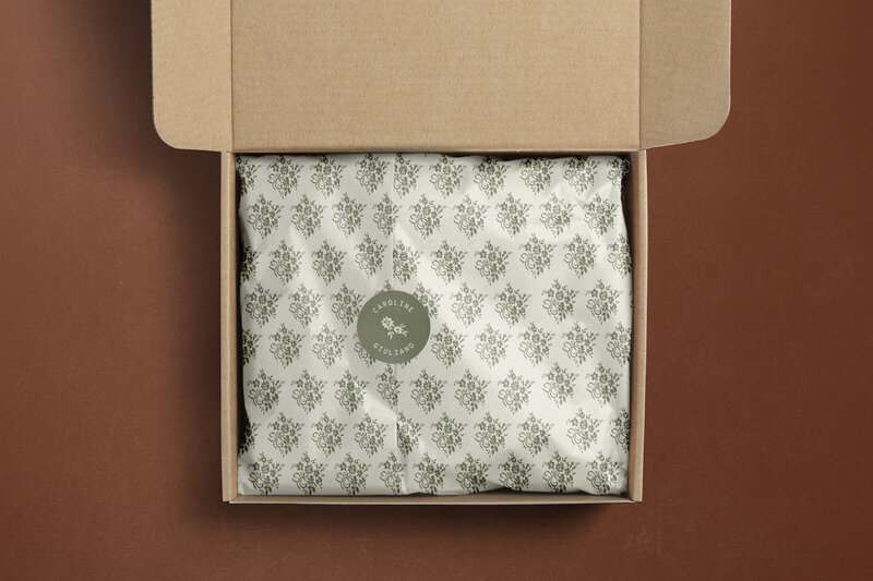 Custom tissue paper and sticker with floral brand motif for photographer