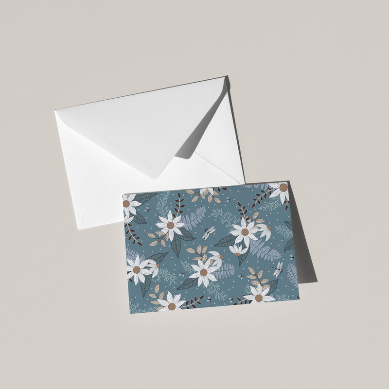 These A6 blank cards are perfect for sending a thoughtful note or simply keeping in your stationery drawer for special moments. Each card showcases a unique hand-drawn design - bunches of daisies and fer fronds with dragonflies on a sea green background - by Green Acre Designs.