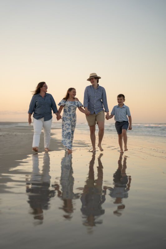 same-sex-copy-family-walk-down-st-augustine-beach-at-sunset