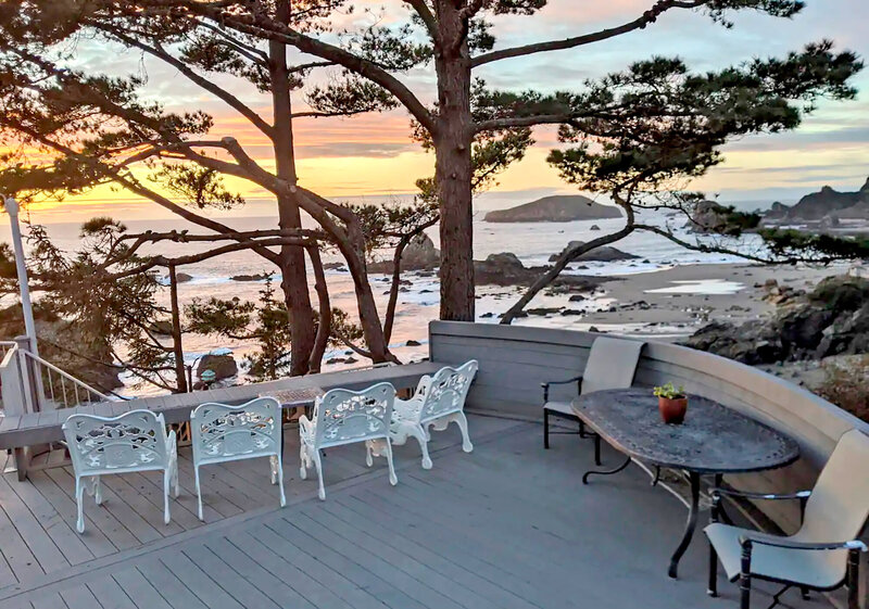 Chairs around a chess table overlooking the ocean during sunset