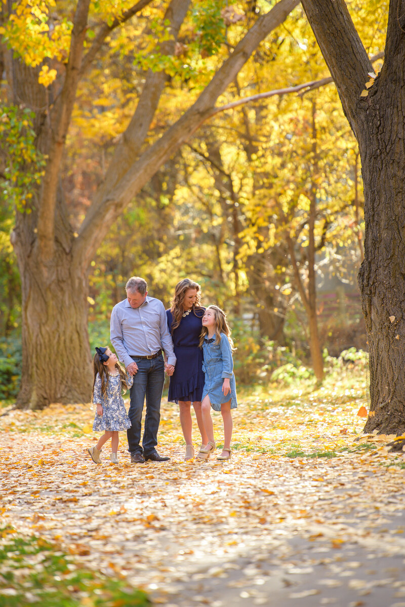 Family looking at each other during fall family portrait session with Boise photographer Tiffany Hix