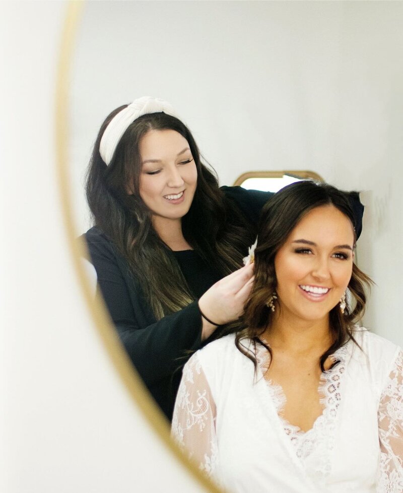 Bridal hair stylist and beauty business coach styling a bride's hair.