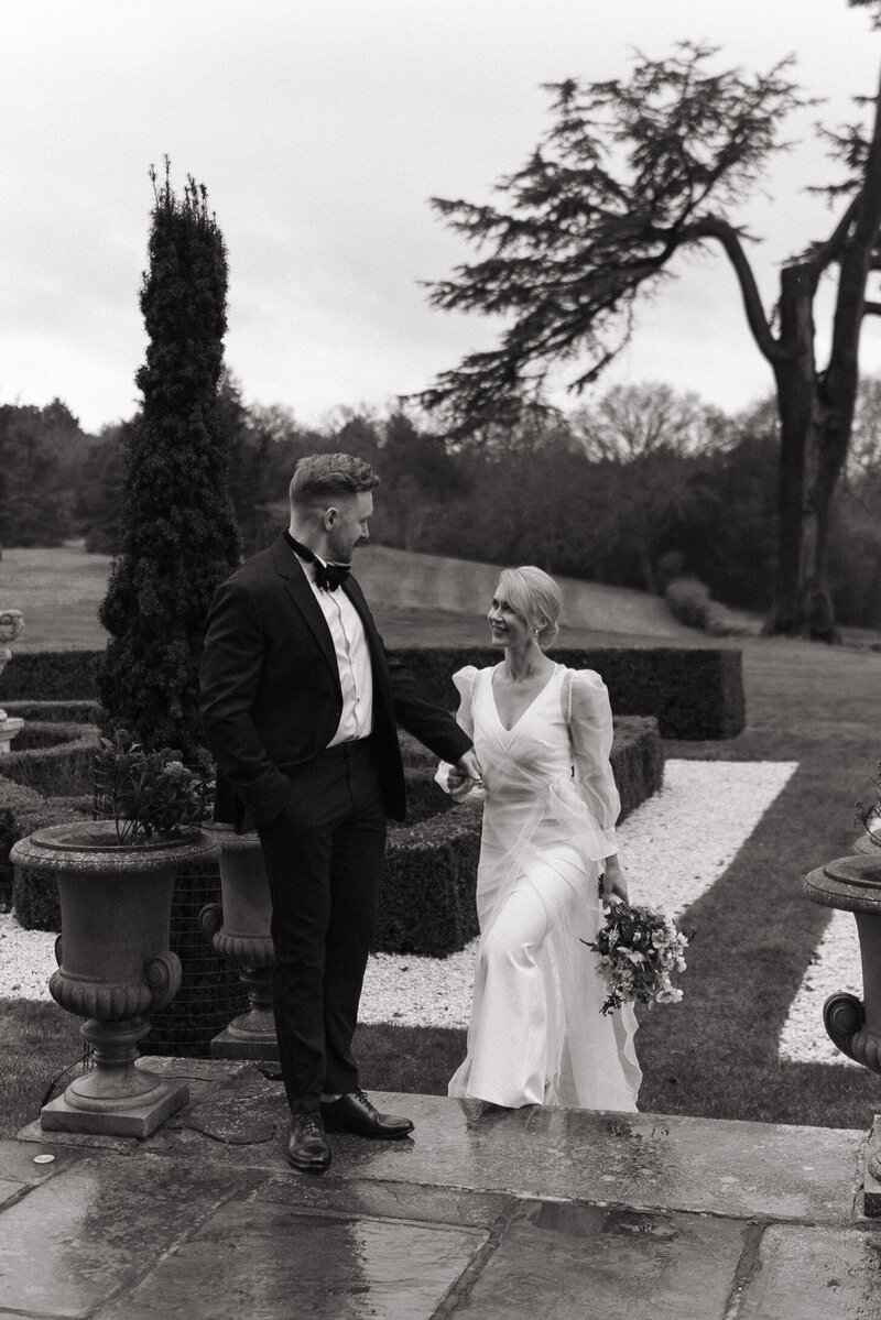 An emotional bride hugs her husband at their luxury wedding reception in the cotswolds