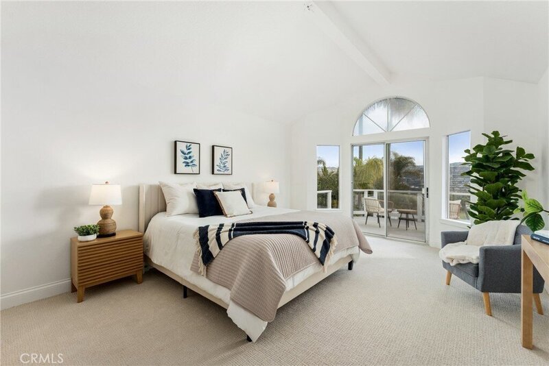 Black, cream, and blue primary bedroom home staging