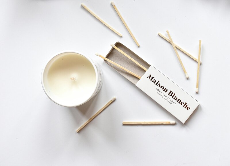 Laptop displaying the website design for social media managers on a minimalist desk with decorative items