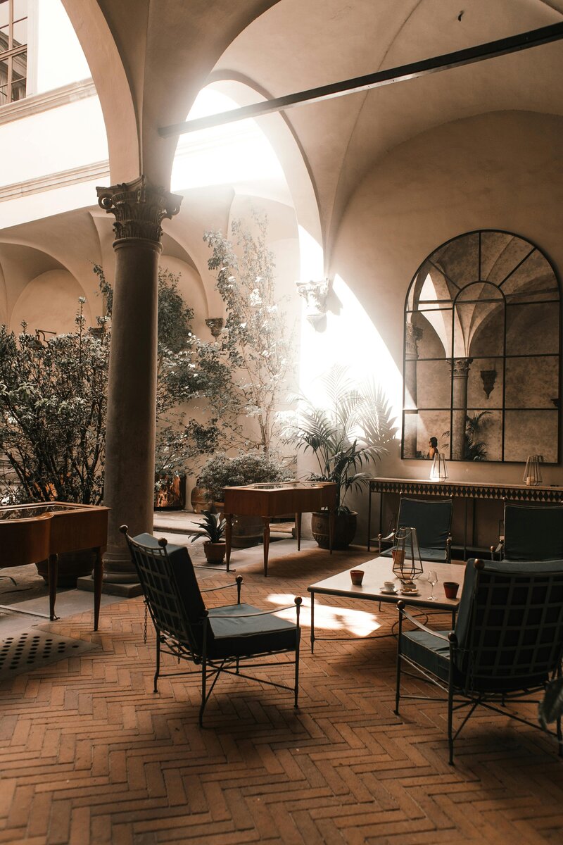 Table and chairs in a room with natural light pouring through