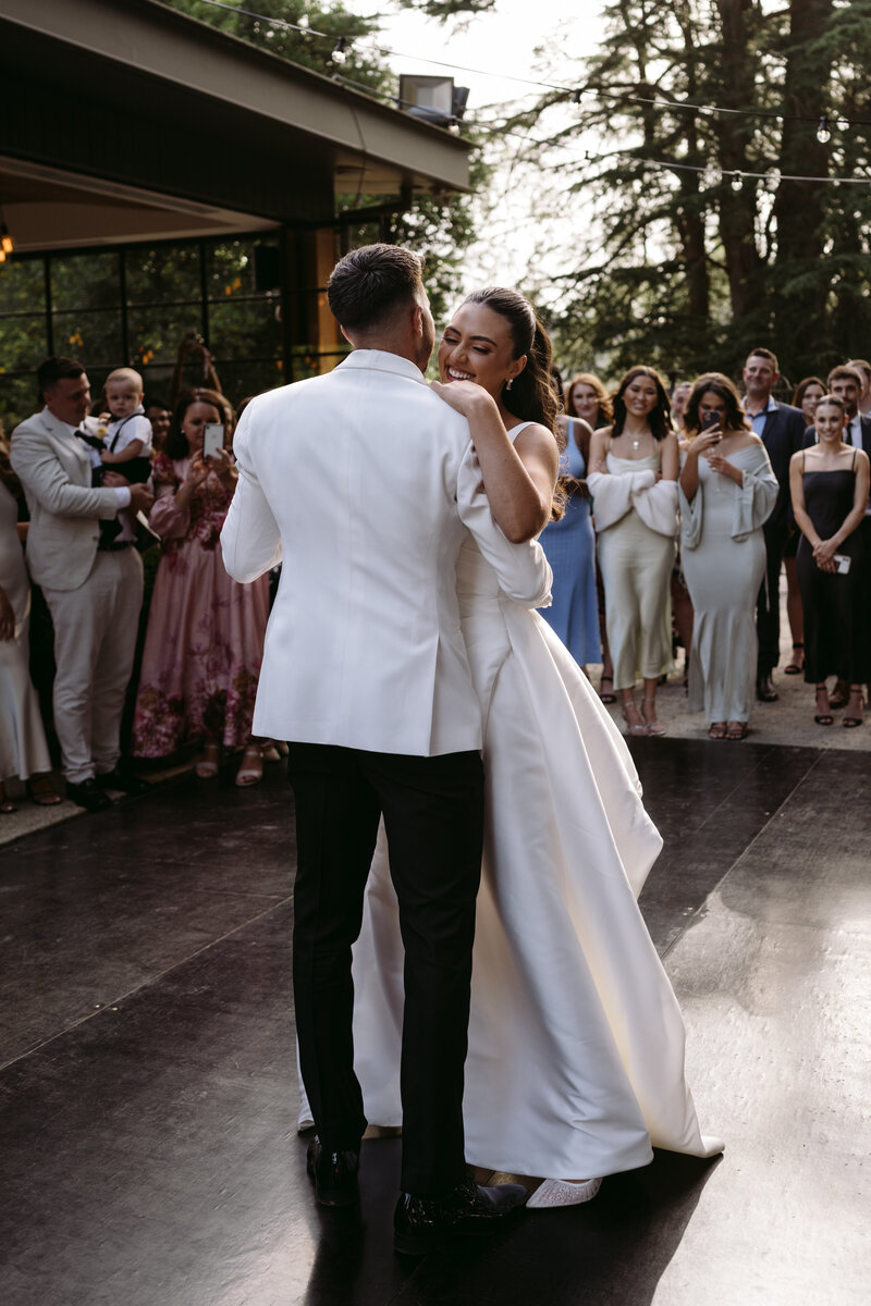 Bride and groom share their first dance at Coombe Yarra Valley, captured by Carry Your Heart Photography. The couple's love shines amidst the elegant ambiance of this historic venue.