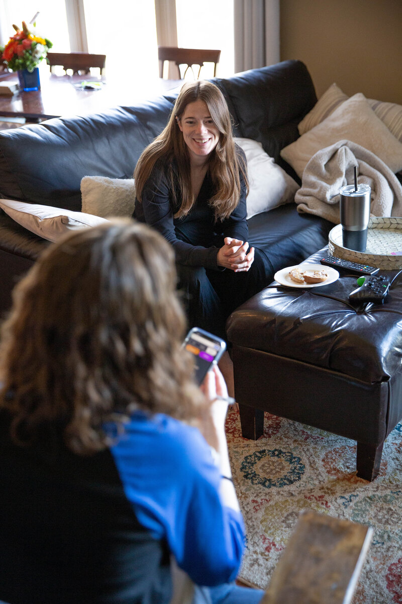 Two women sitting in a living room chatting