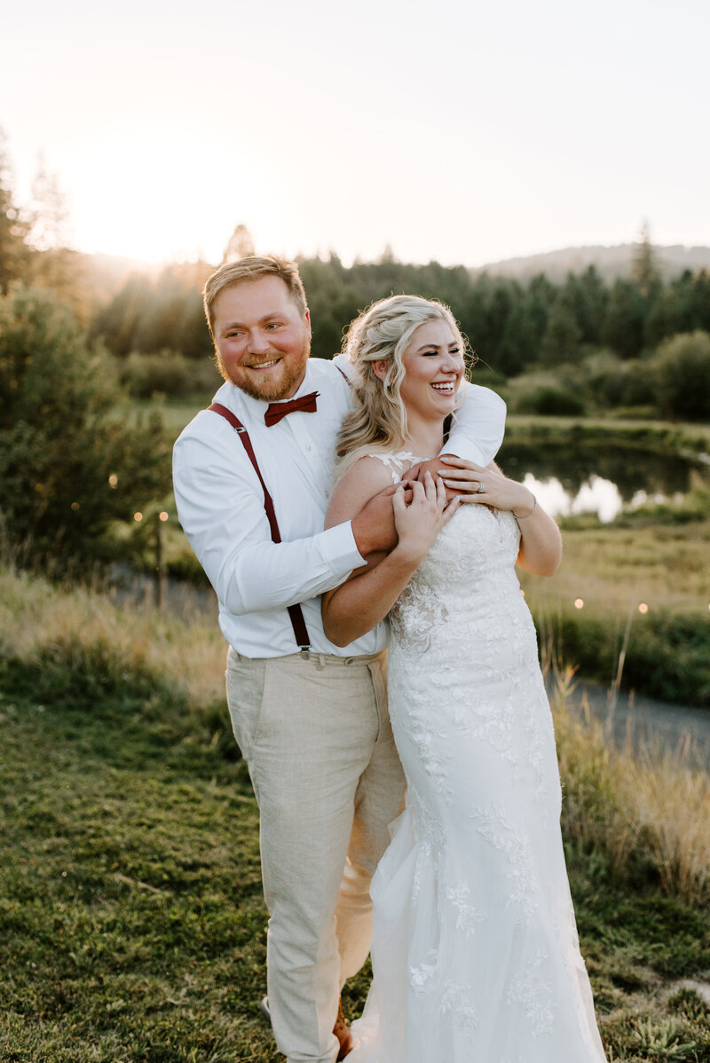 A bride and groom smile at each other in their beautiful wedding venue, Chateau Rive in downtown Spokane, Washington.