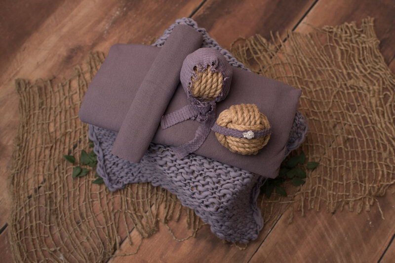 Dusty lilac wrap, headband, hat set on wood background