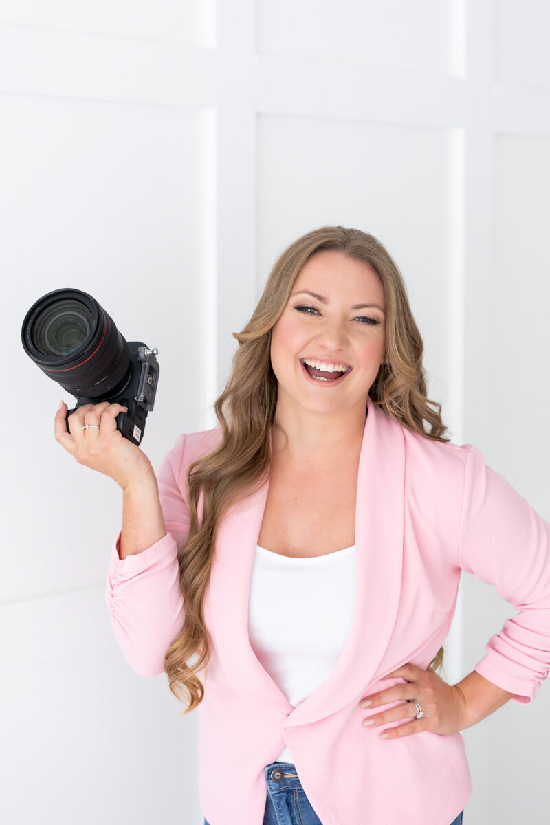 DC engagement photographer holding camera and laughing