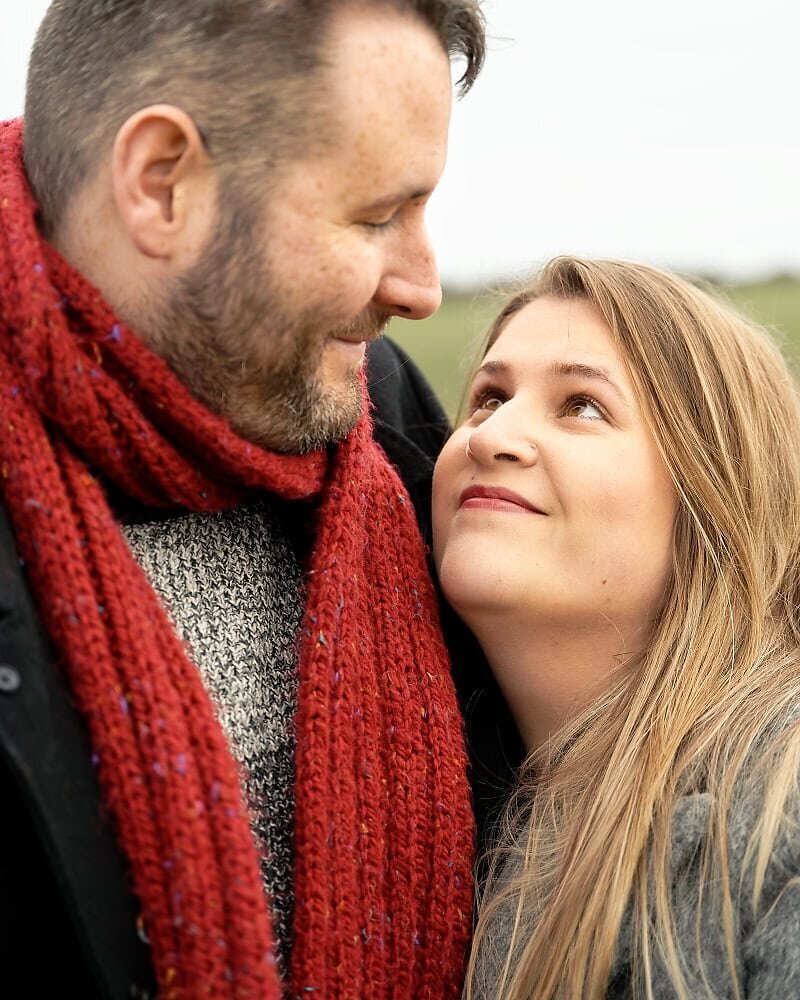 bride to be looking into the eyes of her fiancé at their engagement shoot