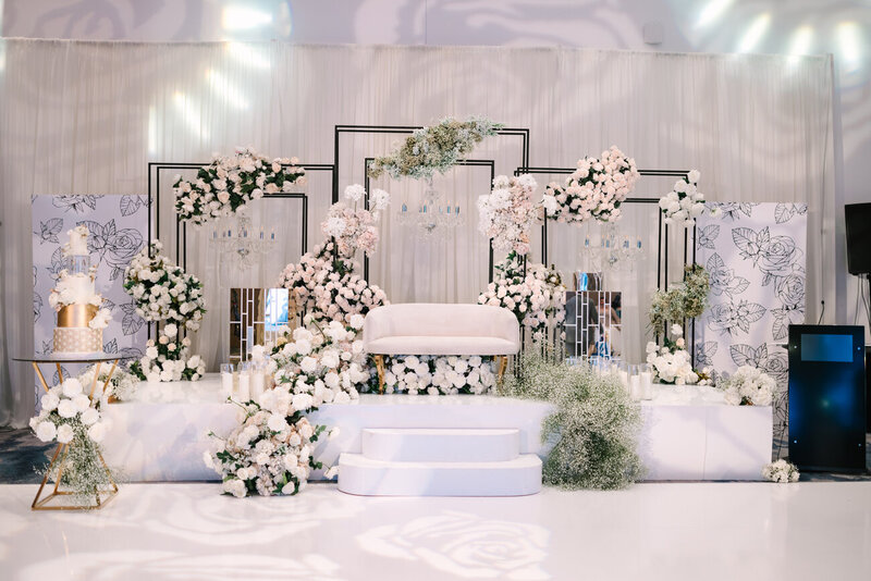Luxurious Indian wedding with baby pink and white floral arrangements.