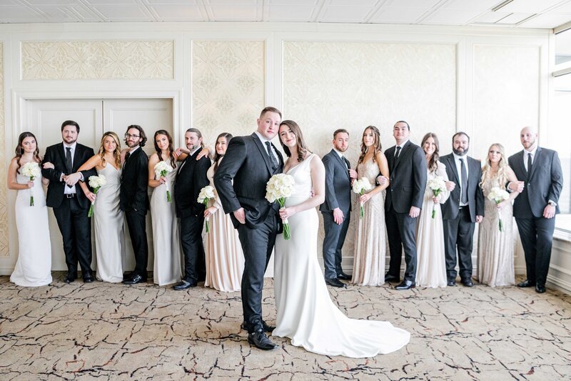 A image of a bride and groom and their wedding party.